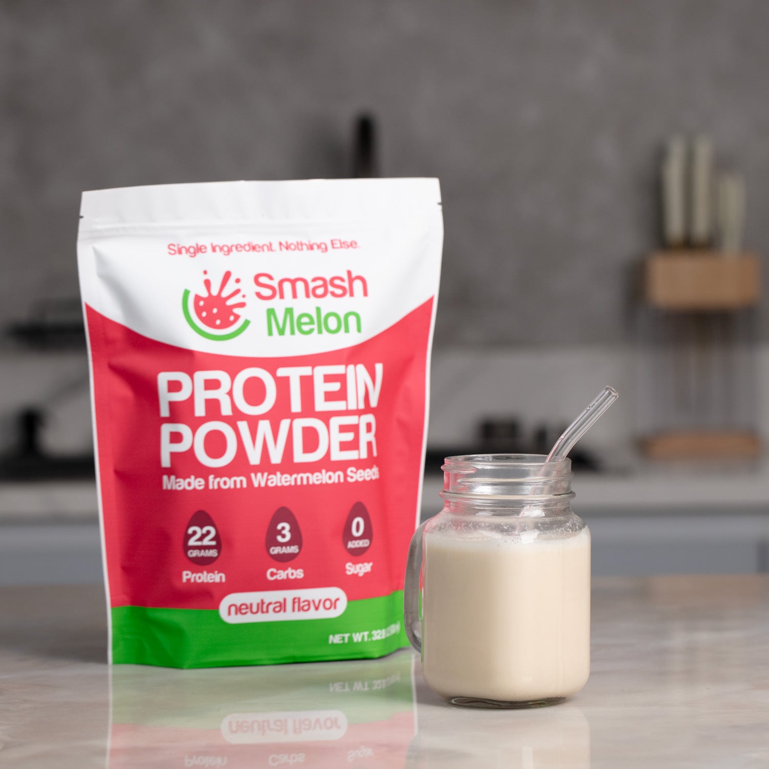 Smash Melon Protein Powder pouch alongside a protein drink in a kitchen setting
